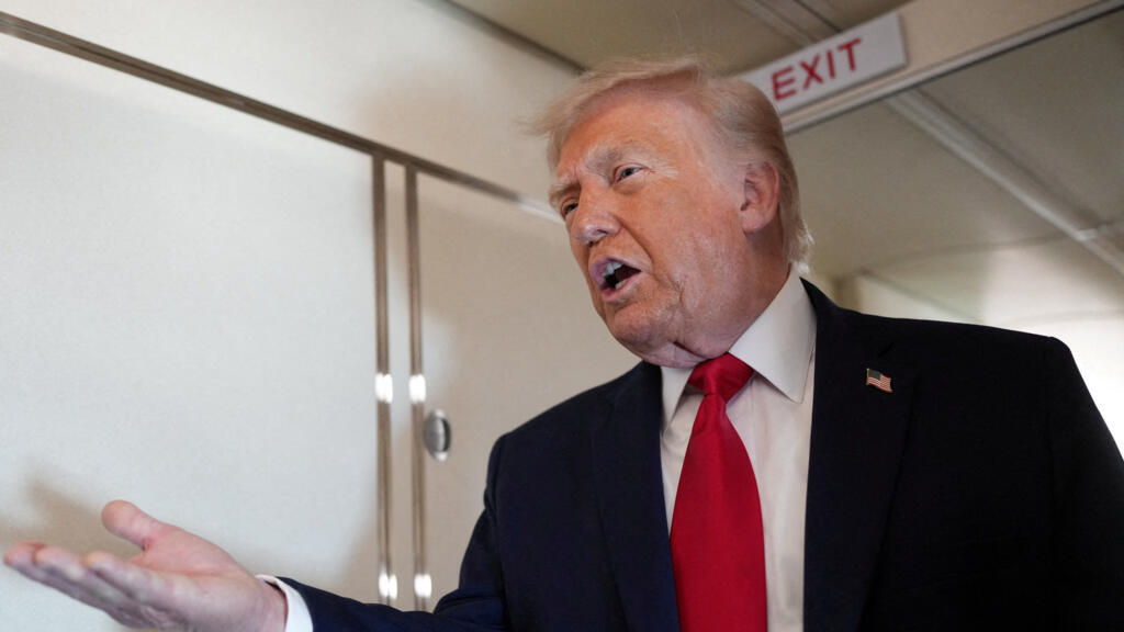 U.S. President Trump speaks to members of the media on board Air Force One en route to Eau Claire, Wisconsin